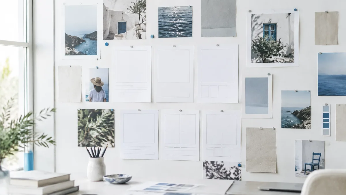 Brand layouts and photographs arranged on a bright studio wall